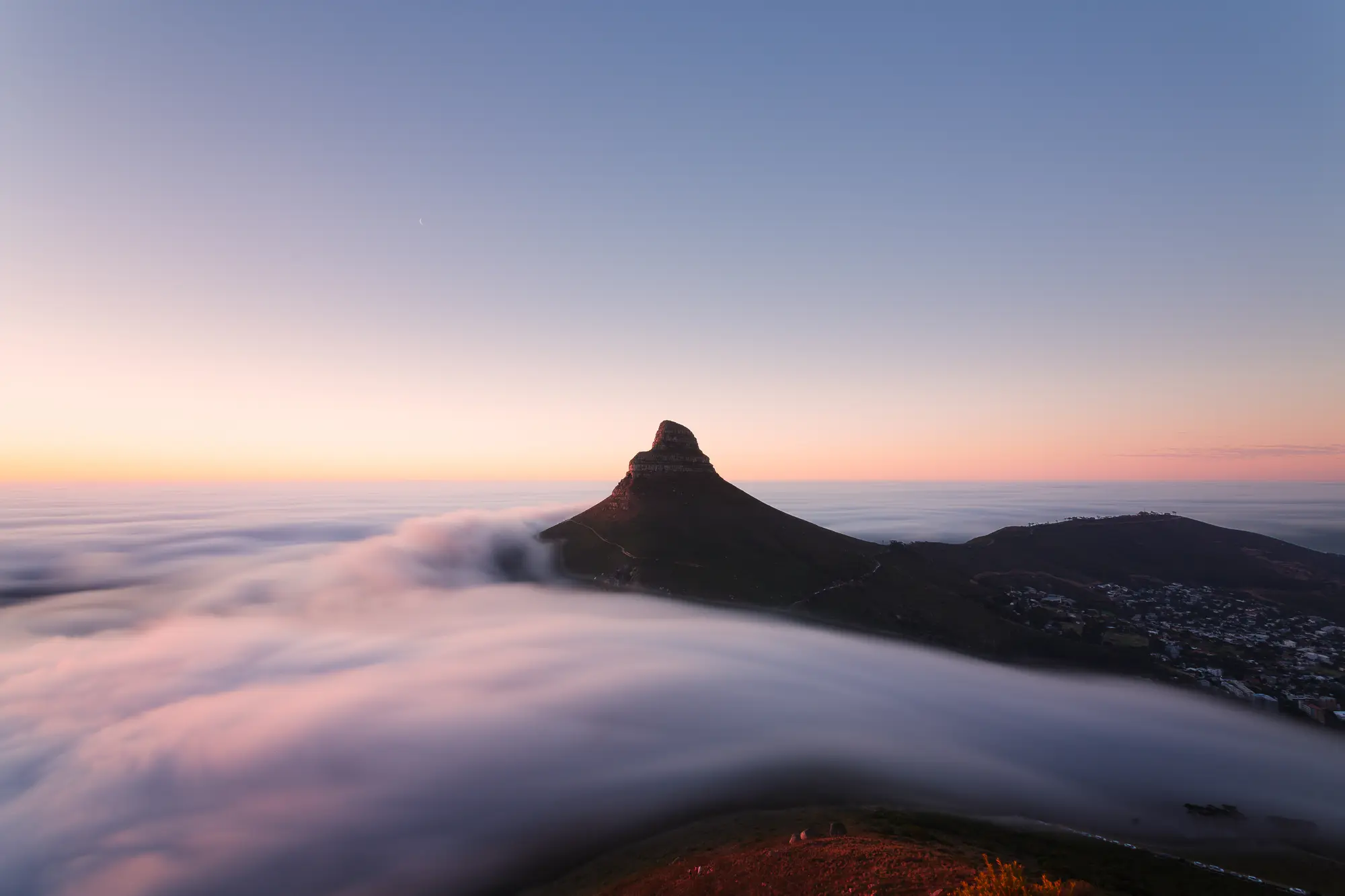 Lion's Head from Kloof Corner holding above a sea of autumn fog rolling in off the Atlantic, sky fading from gold to blue