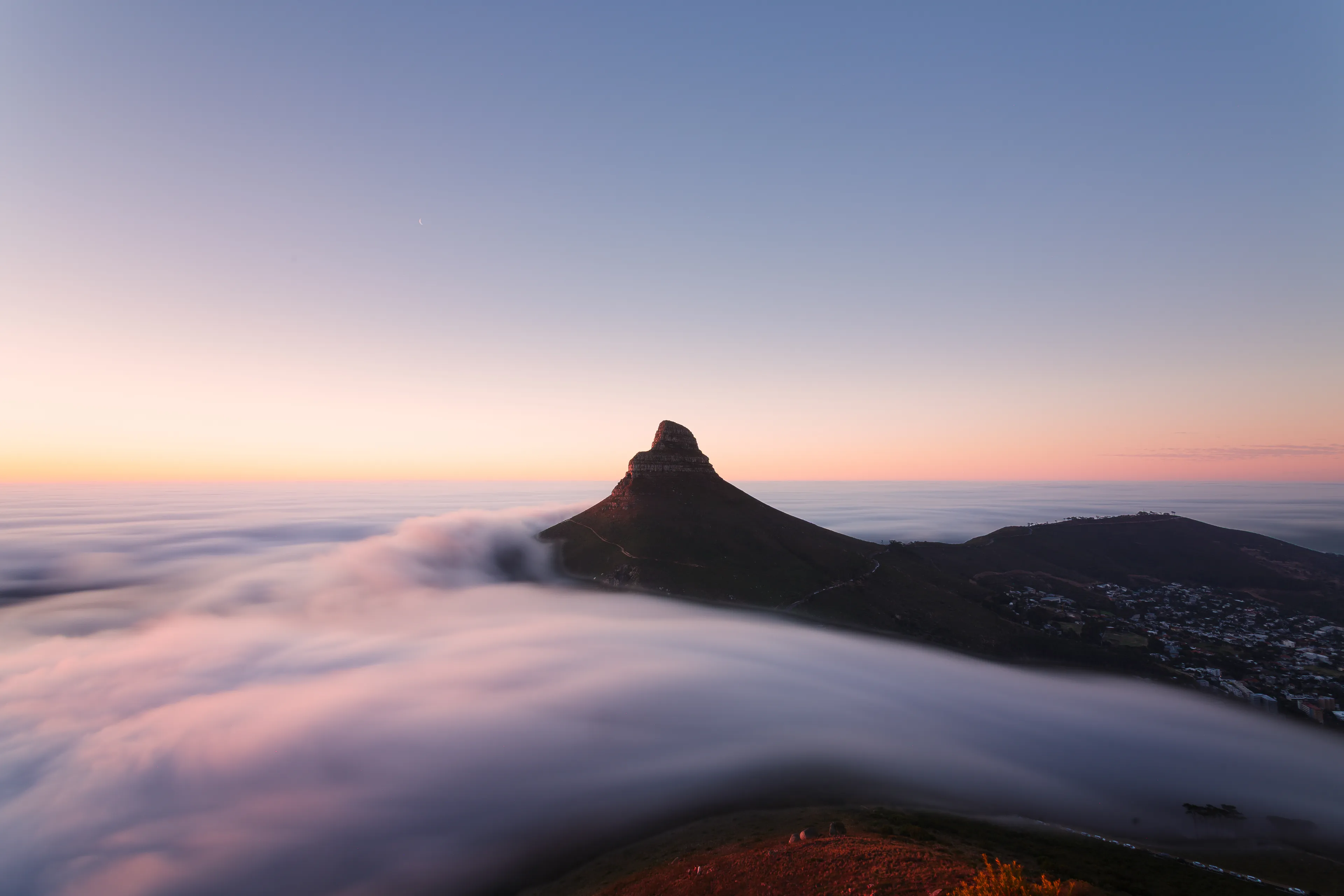 Lion's Head from Kloof Corner holding above a sea of autumn fog rolling in off the Atlantic, sky fading from gold to blue